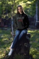 mockup-of-a-woman-wearing-a-hoodie-while-sitting-on-a-lodge-in-the-woods-2794-el1 (3).png
