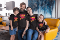 mockup-of-a-family-of-four-wearing-t-shirts-in-the-living-room-28060.png